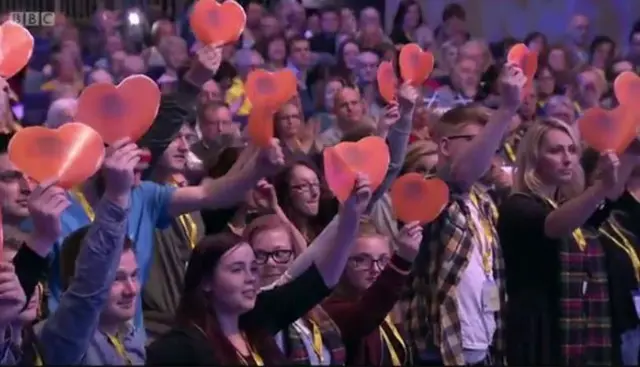 Young people who have grown up in care were in the audience brandishing hearts