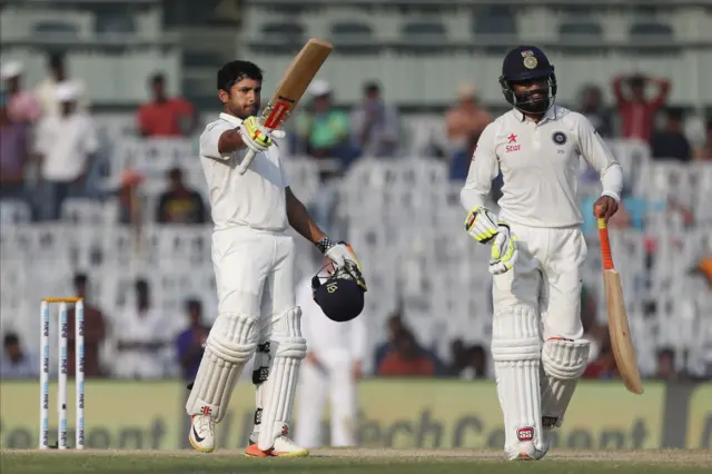 Karun Nair raises his bat after scoring two hundred and fifty runs