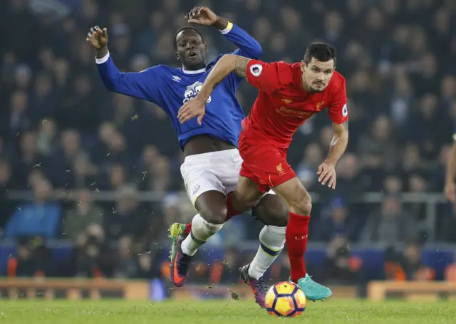 Romelu Lukaku is challenged by Dejan Lovren