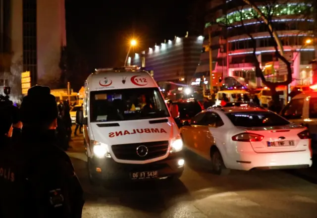 An ambulance leaves the area near an art gallery where the Russian ambassador was shot