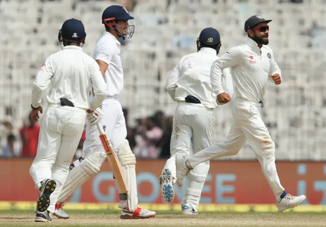 India's players celebrate the wicket of Alastair Cook