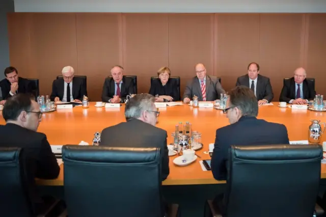 German Chancellor Angela Merkel (centre-back) holds a meeting with security chiefs and ministers in Berlin