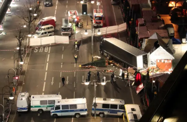 Police search the surroundings of a truck which run into a crowded Christmas market the evening before and killed several people in Berlin, Germany, on 20 December, 2017.