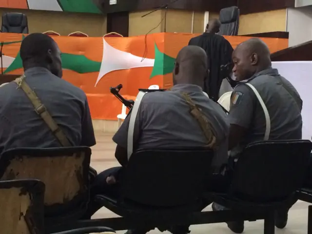 A security guard snoozes as he waits for ex-First Lady Simone Gbagbo to appear in court