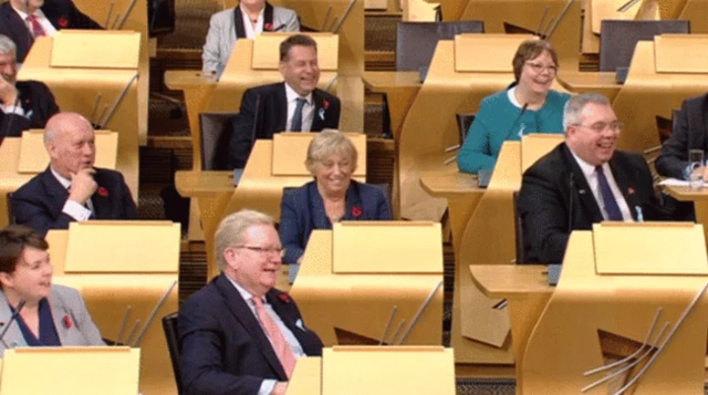 Alex Johnstone and Tory colleagues laugh in the chamber