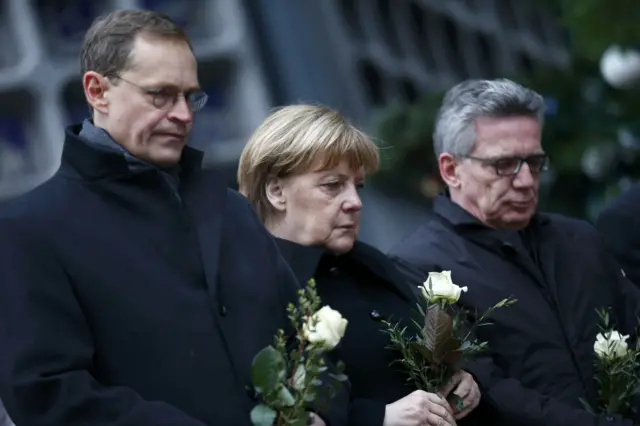 Angela Merkel lay flowers