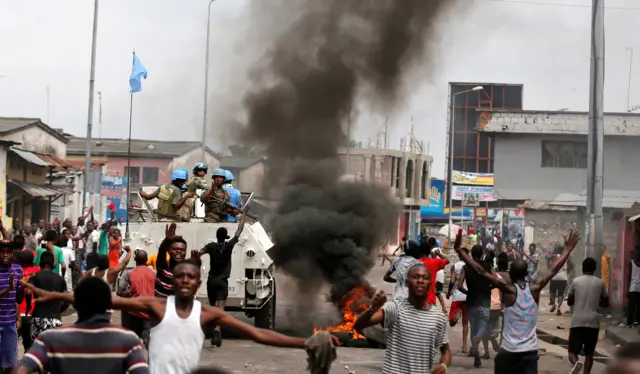 Residents chant slogans against Congolese President Joseph Kabila as peacekeepers serving in the United Nations Organization Stabilization Mission in the Democratic Republic of the Congo (MONUSCO) patrol during demonstrations in the streets of the Democratic Republic of Congo"s capital Kinshasa, December 20, 2016.