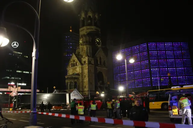 Security and rescue workers tend to the area after a lorry truck was ploughed through a Christmas market on 19 December 2016 in Berlin, Germany.