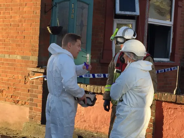 Forensic staff outside house