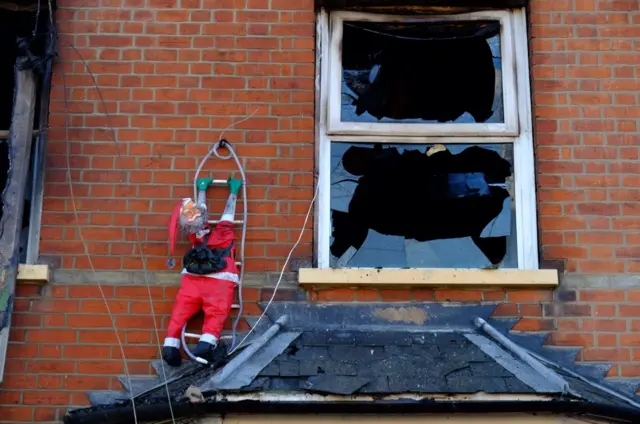 Santa climbing the house