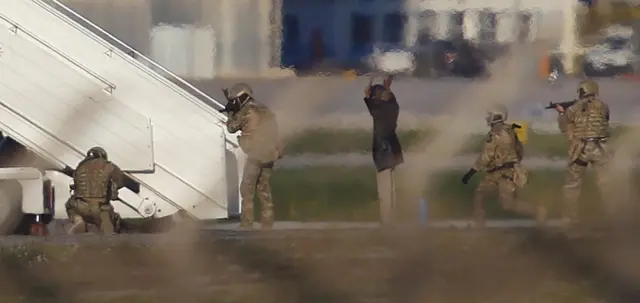 Two hijackers of a Libyan Afriqiyah Airways Airbus A320 surrender to Maltese military on the runway at Malta Airport, December 23, 2016.