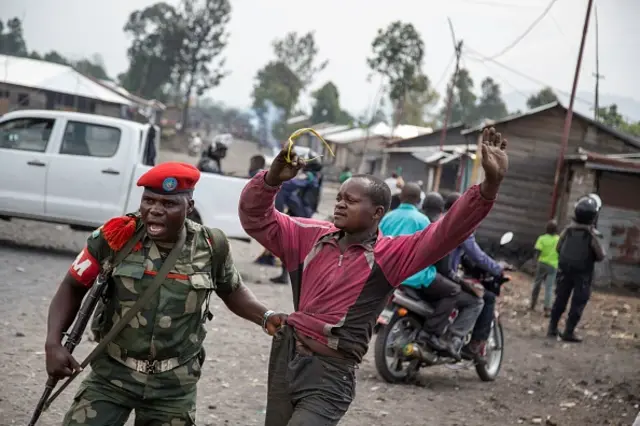 A man is arrested by a member of the military police after people attempted to block the road with rocks, in the neighbourhood of Majengo in Goma, eastern Democratic Republic of the Congo, on 19 December, 2016