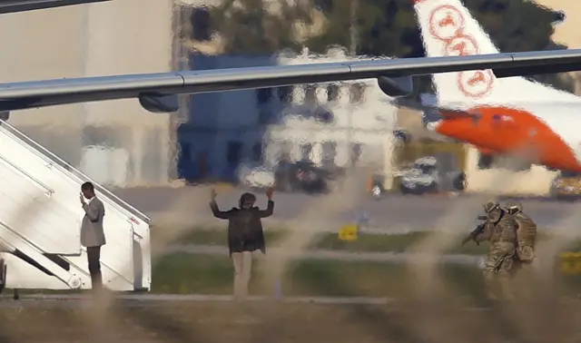 Two hijackers of a Libyan Afriqiyah Airways Airbus A320 surrender to Maltese military on the runway at Malta Airport, December 23, 2016