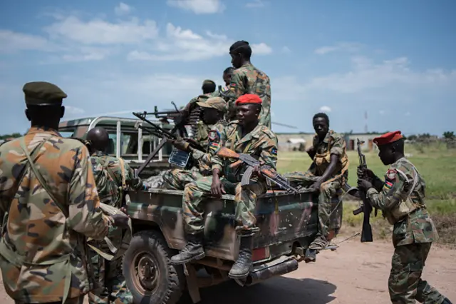 Sudan People Liberation Army (SPLA) soldiers stand on a pick up truck on their way to the river side to ride on a boat on the Nile, as they head to Alole, northern South Sudan, on October 16, 2016.