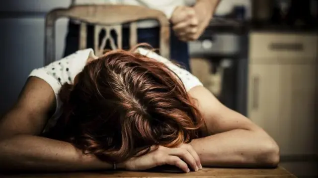 Woman with her head on a table