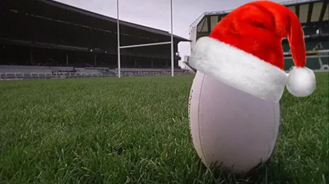 Rugby ball with a santa hat on