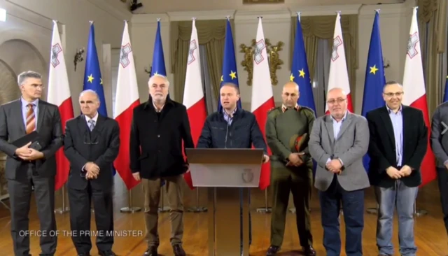 Maltese prime minister stands at lectern