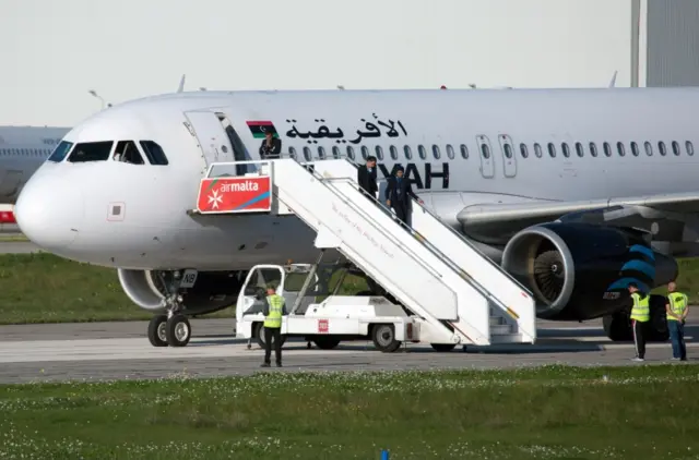 Female crew members leave the hijacked Afriqiyah Airways A320 airplane at the Malta International Airport in Luqa, Malta, 23 December 2016