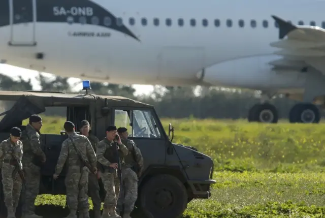 Maltese troops survey a hijacked Libyan Afriqiyah Airways Airbus A320 on the runway at Malta Airport, December 23, 2016