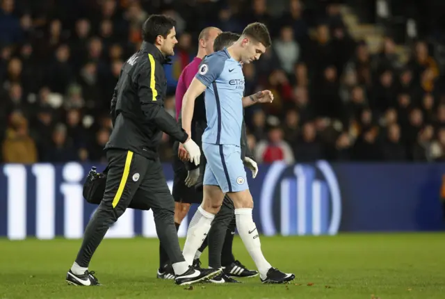 John Stones limps off