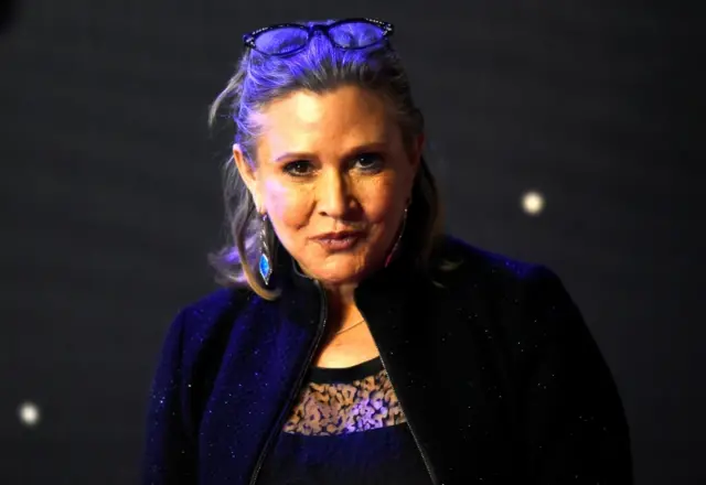 Carrie Fisher poses for cameras as she arrives at the European Premiere of "Star Wars, The Force Awakens" in Leicester Square, London, December 16, 2015.