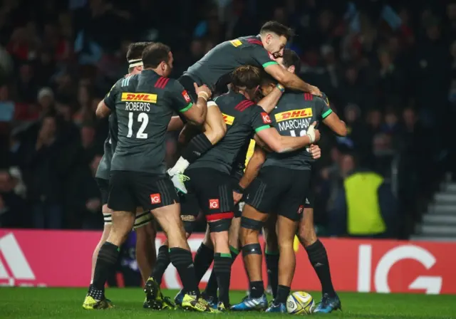 Harlequins celebrate scoring the opening try