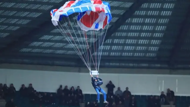 Man with a parachute drops into Twickenham