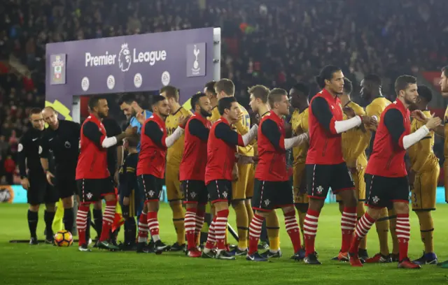 Players and officials shake hands