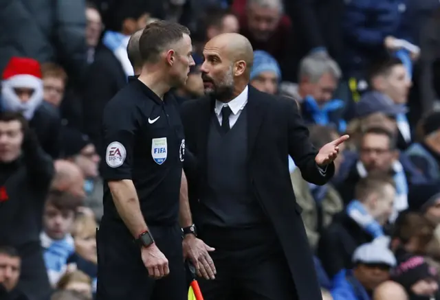 Man City's Manager speaks to the Assistant Referee