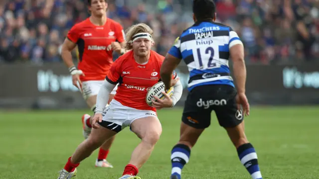 Jared Saunders of Saracens runs at Ben Tapuai of Bath