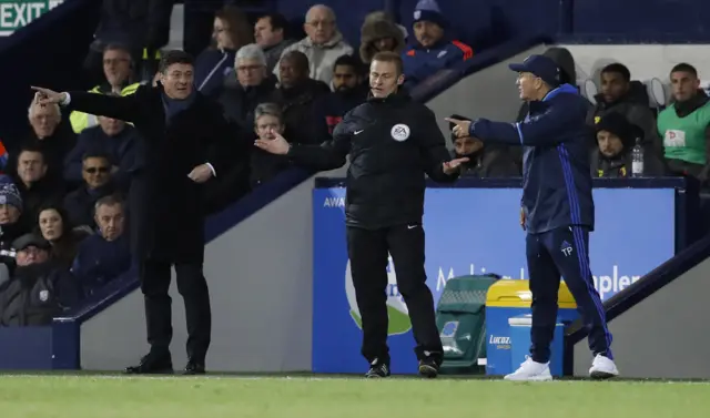 The two managers talk to the fourth official