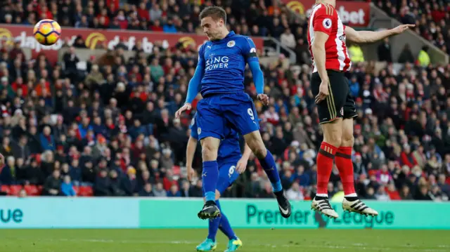 Jamie Vardy heads at goal