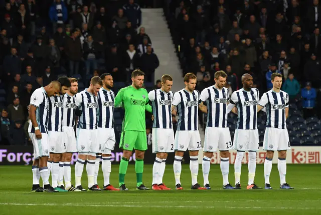 West Bromwich Albion players observe a minutes silence