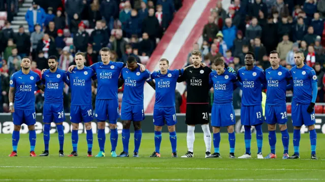 Leicester City players observe a minutes