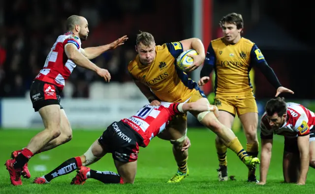 Mitch Eadie of Bristol Rugby is tackled by Billy Burns of Gloucester