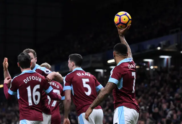 Andre Gray of Burnley holds up the match ball