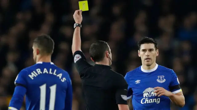 Gareth Barry is shown a yellow card