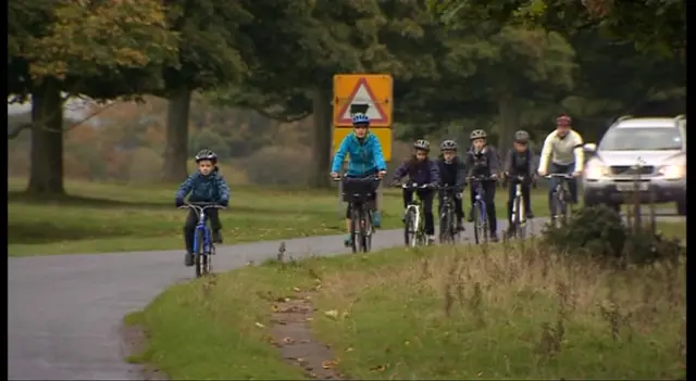 Family cycling along a road