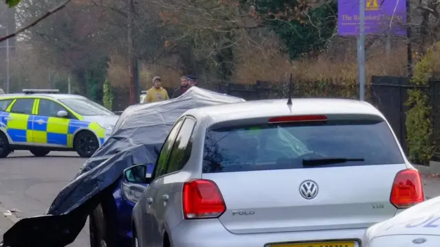 Tarpaulin covered car