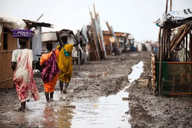 Women carry their belongings inside the Protection of Civilians (PoC) site in Malakal, on June 14, 2016.