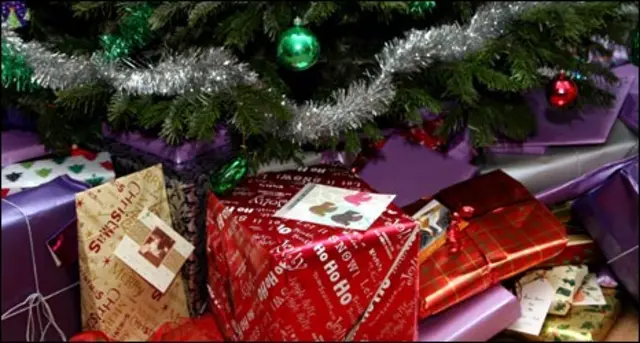 A pile of Christmas presents under a tree