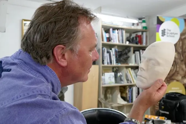 Andrew Sinclair with mask of David Bowie's face