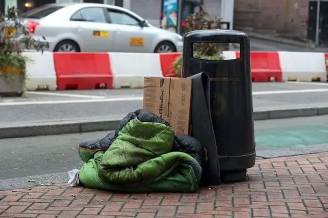 Sleeping bag next to a bin