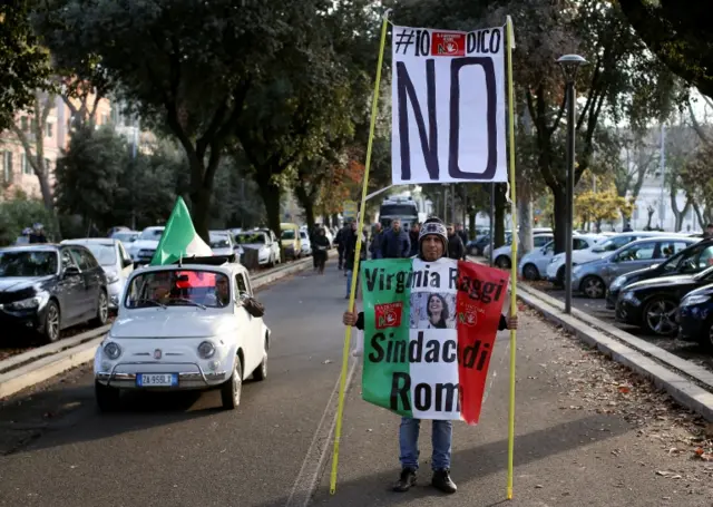 A man holds a banner reading "I say no" during a march in support of the "No" vote in the constitutional reform referendum in Rome