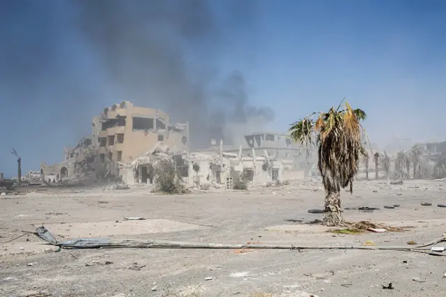 Smoke rises from a destroyed neighbourhood as fighting continues between pro-Libyan government fighters and the Islamic State (IS) in Sirte on September 22, 2016.