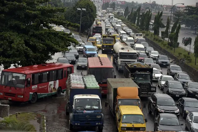 Vehicles are stuck in a traffi jam in Lagos, on August 20, 2015.