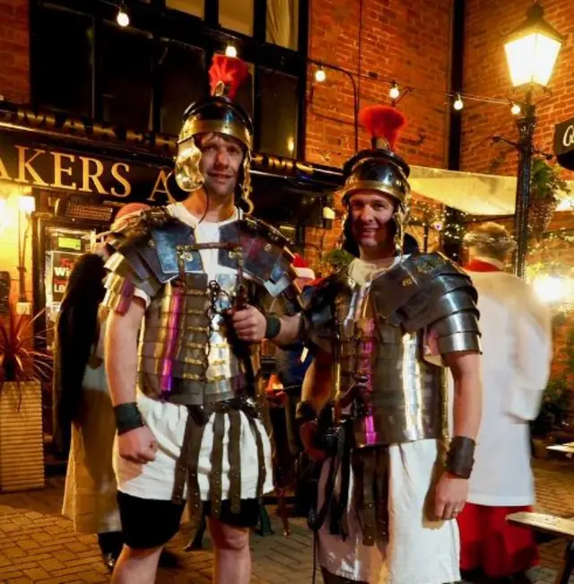 Two men wearing roman soldier costumes