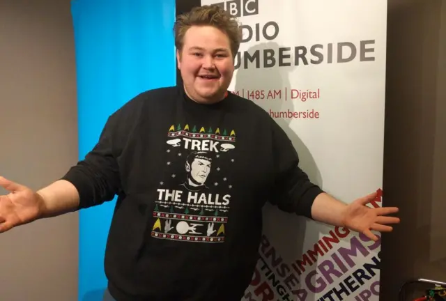 Terence in a Christmas jumper that says Treck the Halls and has a picture of Spock on it.