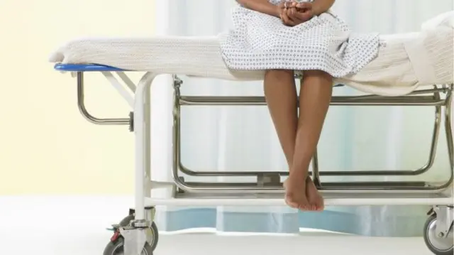 Girl sits on hospital bed