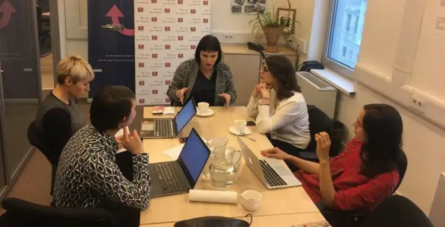 Russian Service journalists around desk